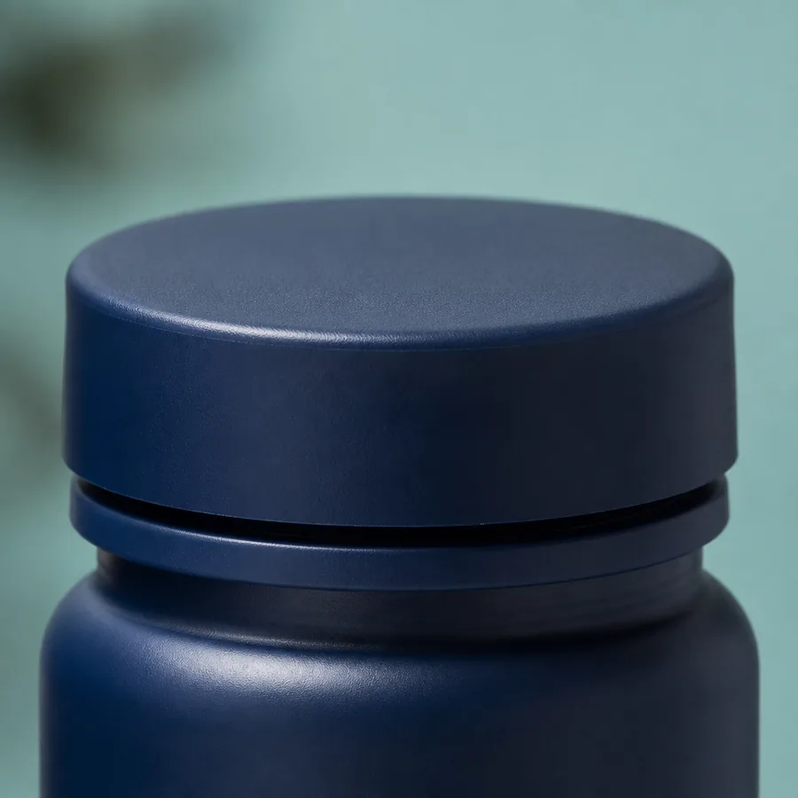Close-up of matte navy supplement bottle cap